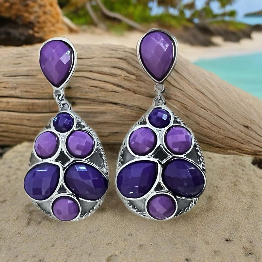 Earrings in shades of purple and silver on a post setting